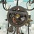 Vintage 7 Light Wrought Iron Wall Sconce With Milk Glass Flowers & Cherub Motif Matching Sconce Available Separately For Sale - Image 11 of 12
