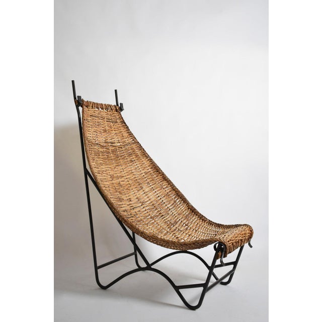 Wrought iron and rattan armchair, 1950s. Height: 146 cm - 57.48 in Length: 85 cm - 33.46 in Width: 105 cm - 41.34 in...