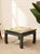 A bold vintage side table with a wildly expressive marbled top swirling with saturated yellow, orange, deep teal, and...