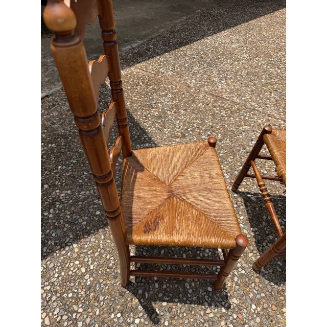 This is a pair of vintage Tell City Chair Company chairs circa 1924 - 1943. The tall ladder back chairs feature the...