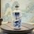 This Chinese porcelain snuff bottle is decorated in underglaze cobalt blue, featuring a stylized landscape composition...