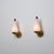 Elegant pair of italian wall sconces from the 1950s, distinguished by their refined tapered silhouette and playful use of...