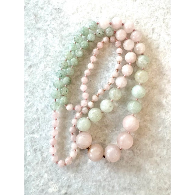 A beautifully unique, two toned hand strung and hand tied beaded necklace made from rose quarts and jade.