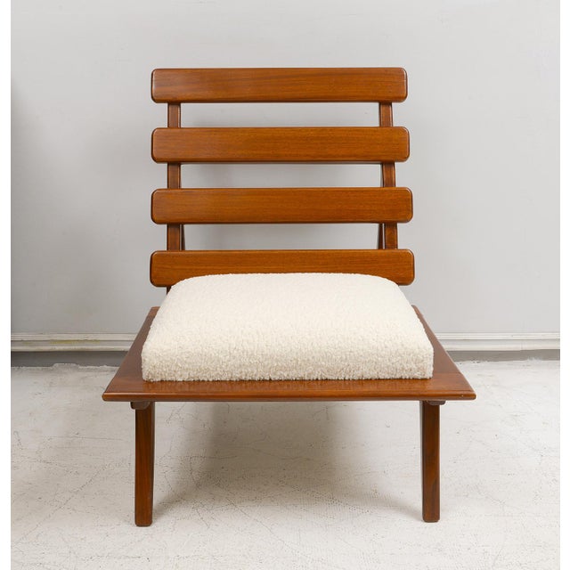 Pair of sculptural mahogany lounge chairs upholstered in boucle fabric. Set of 2.
