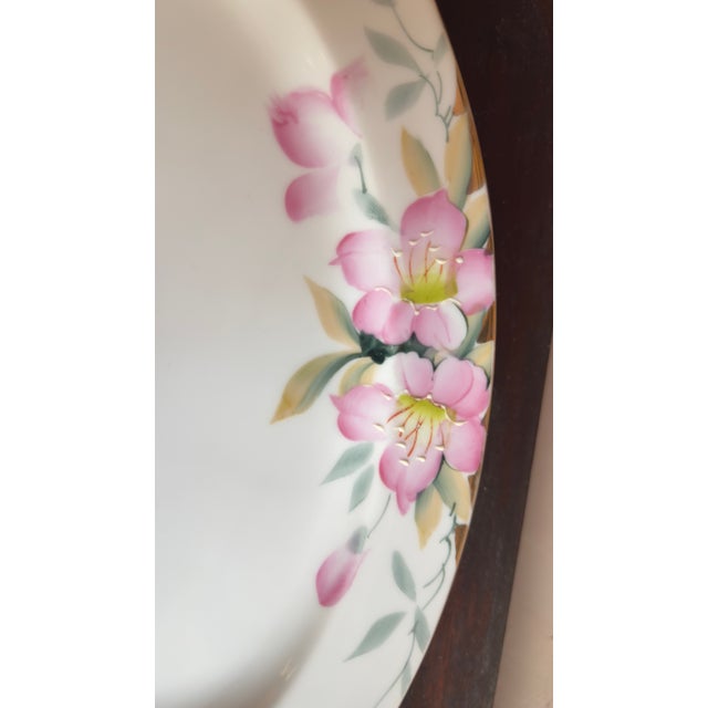 This early 20th century Noritake porcelain set features the Azalea pattern with hand-painted pink flowers and gold trim....