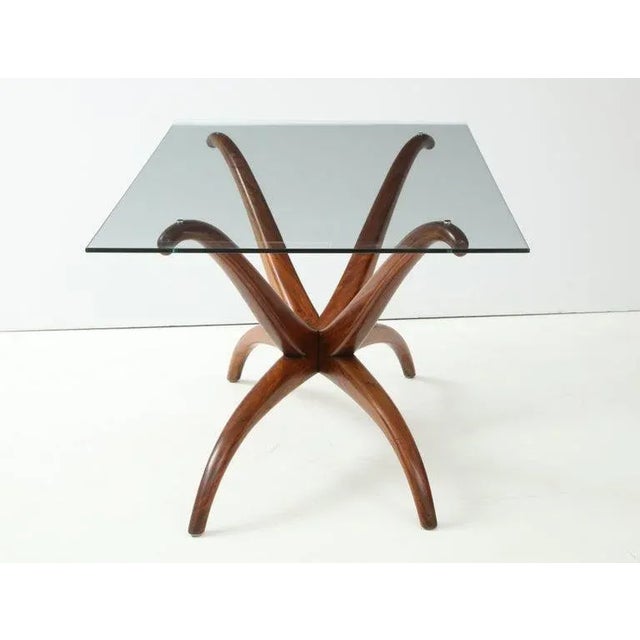 A rare and important 1950s sculptural walnut wood table By Brazilian mid century master, Giuseppi Scapinelli. The glass...