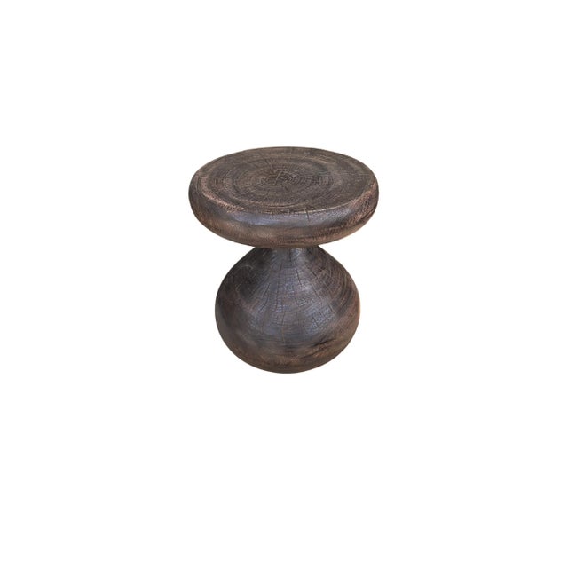 A wonderfully sculptural round side table, with an hourglass shape. Its neutral pigments make it perfect for any space. A...