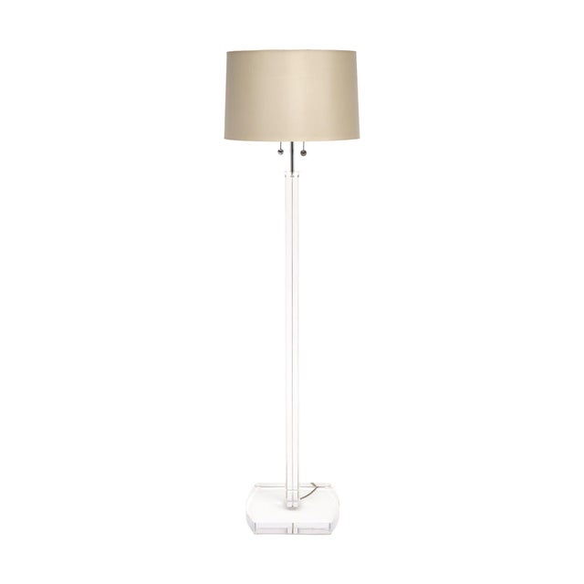 Floor lamp from France in the modernist style. This fixture has a Lucite base and Lucite column that support chrome...