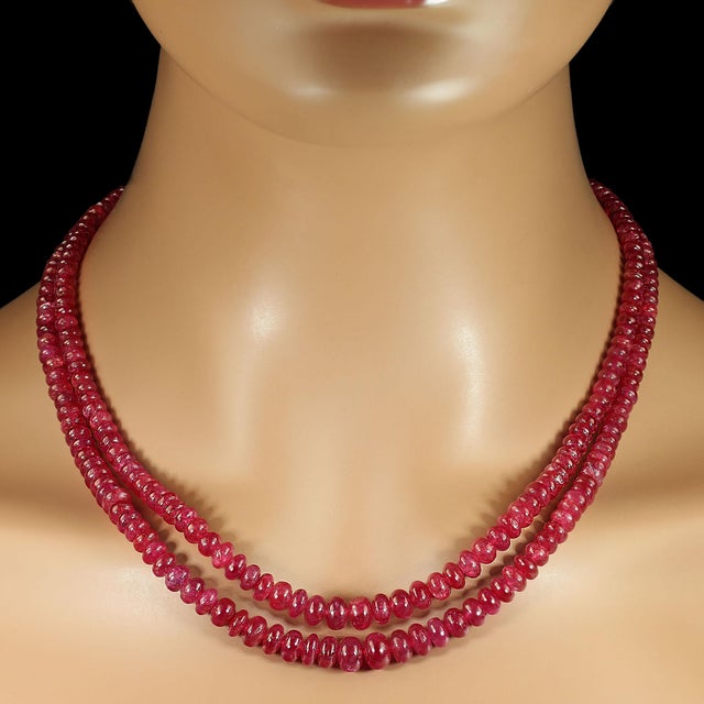 This exquisite two‑strand ruby necklace showcases a glowing array of graduated, smooth rondel‑shaped rubies ranging from...