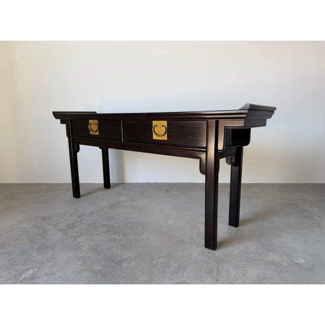 Elegant vintage Chinoiserie-style console table by Century Furniture, featuring a rich black lacquered ebonized finish and...
