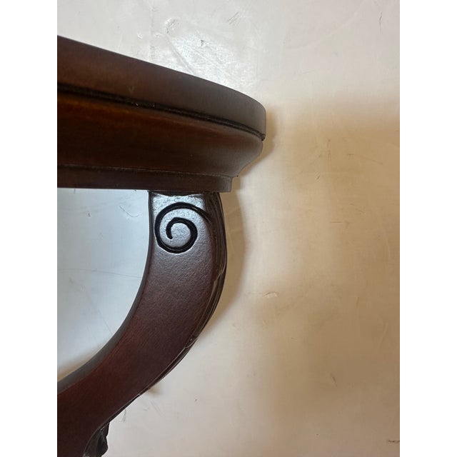 Pair of lovely carved mahogany wall brackets having classic elegance and offering wonderful surfaces for display.