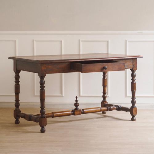 This antique solid oak table combines historic craftsmanship with timeless appeal. The turned legs and sturdy central...