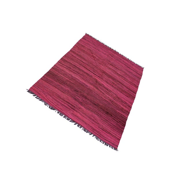 Add a touch of elegance to your home with this casual chic hand woven Tribal Kilim wool rug. Constructed on a loom by...