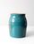 This is a vintage stoneware cookie jar circa 1930s. Hand-painted flowers color the face of the teal blue jar with coral...