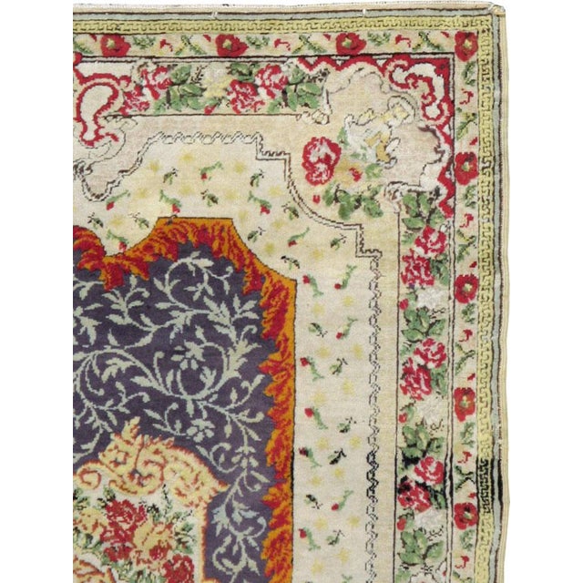 An antique Turkish Hereke carpet from the first quarter of the 20th century. The geometric medallion and guard-border are...