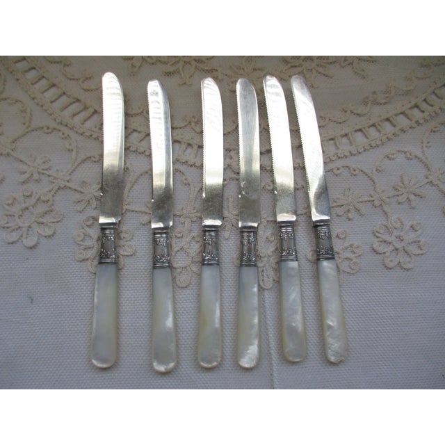 This is a Beautiful Set of Six Landers, Frary & Clark Aetna Works Knives in Mother of Pearl with Ornate bands that have a...