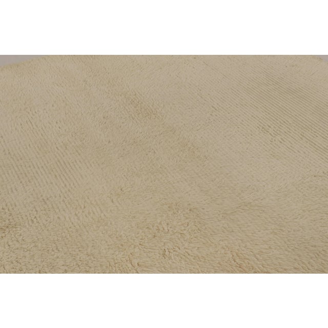 Made with hand-knotted high-pile wool in Turkey, this 7x7 vintage Tulu rug is a distinguished addition to Rug & Kilim’s...