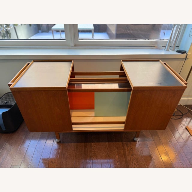 This stylish bar cart features a rich teak finish and smooth rolling casters for easy service. Expandable cart with...