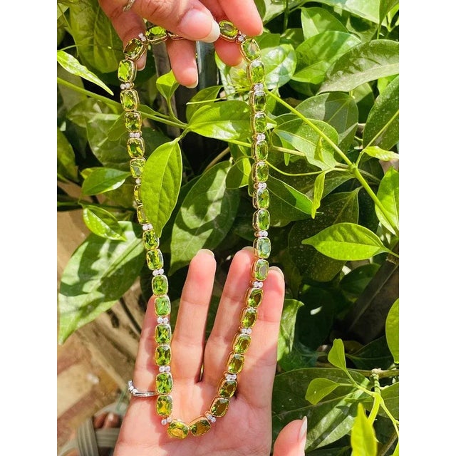This is part of Chairish’s Fine Jewelry assortment. Peridot Necklace in 18K Gold studded with cushion cut peridot pieces...