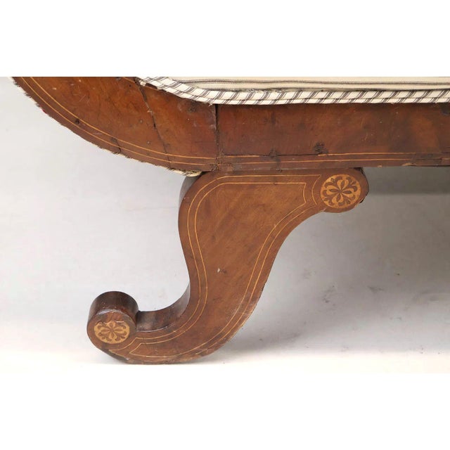 This antique chaise lounge is an elegant and sculptural piece to the 19th century. The gracefully scrolled ends are...