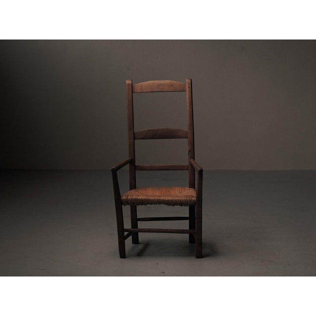 19th century rural armchair from the Auvergne region is crafted from solid wood and features a simple yet robust...