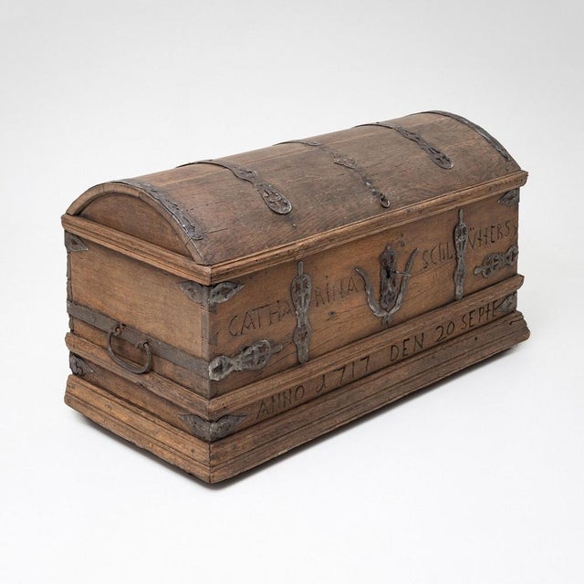 An impressive Baroque domed chest crafted from oak and adorned with intricate iron fittings. The chest bears the...