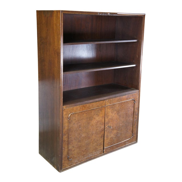 Mid Century Bookcase, Circa 1940s. Features a rectangular frame made from walnut with burlwood with three shelves over a...