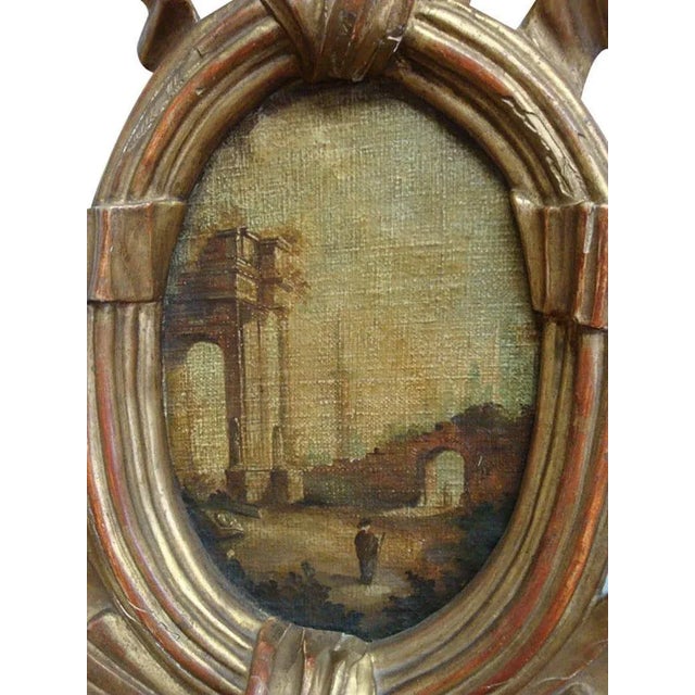 This large wall hanging clock was carved in Paris, France, circa 1780. The antique clock is topped with a cartouche frame....