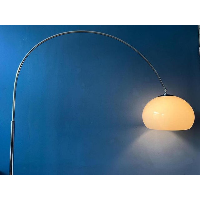 Mid century arc floor lamp by Guzzini with white mushroom shade and marble base. The purple acrylic glass shade produces a...