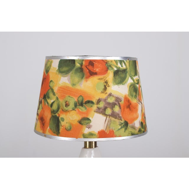 Two Sgrafo Modern porcelain lamps, 1950s, with a flattened cone profile, underglaze floral decoration, and period shades....