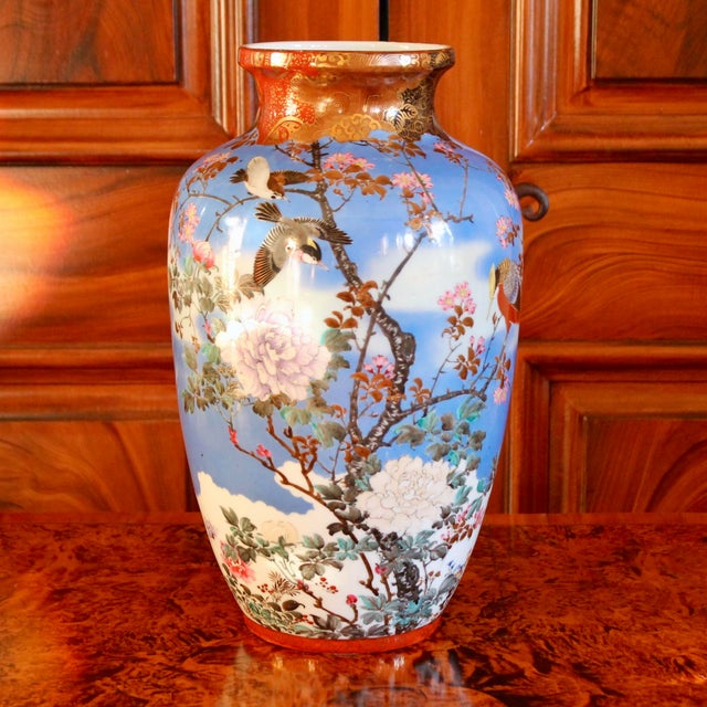 A large and unusual Japanese vase in a spectacular color palette of turquoise, orange and gold, featuring birds and...