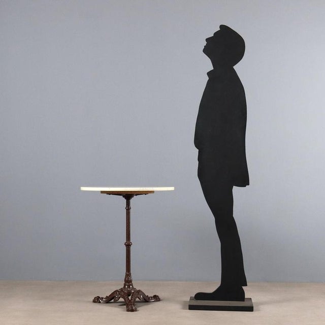 Set of three coffee tables. White marble top supported by a turned central leg resting on three lacquered iron feet with...