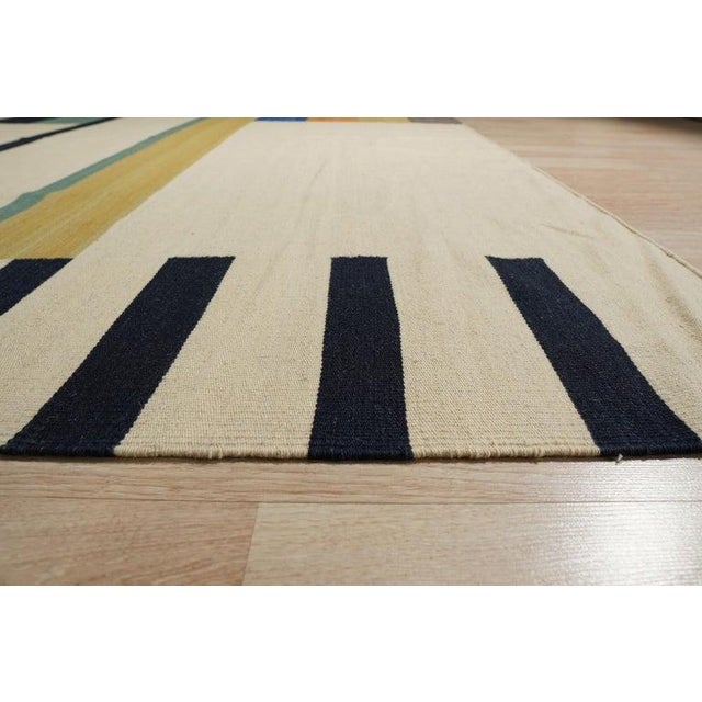 This multicolor jewel tone rug is a hand knotted pile wool rug designed in a distinct Kilim style. Originating from India,...