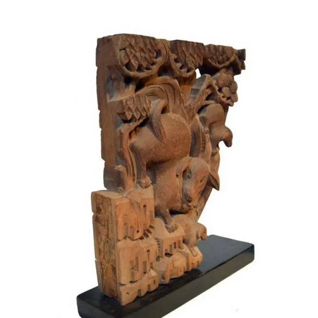 A pair of Chinese 18th century hand-carved wooden temple corbels. Each corbel features detailed animals, shells, and other...