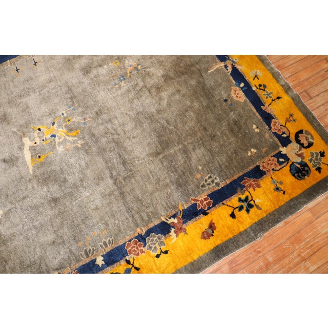 Full Pile Chinese intermediate size rug from the 2nd quarter of the 20th century featuring a bright yellow border and gray...
