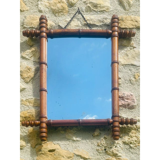 Early 20th century, vintage, French mirror, in a rich, golden brown colored, “faux bamboo'' e, made of beech, with a...