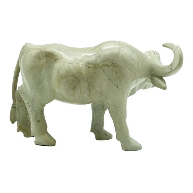 A found soapstone cattle statue, hailing from the heart of Kenya. Each curve and contour of this exquisite piece has been...