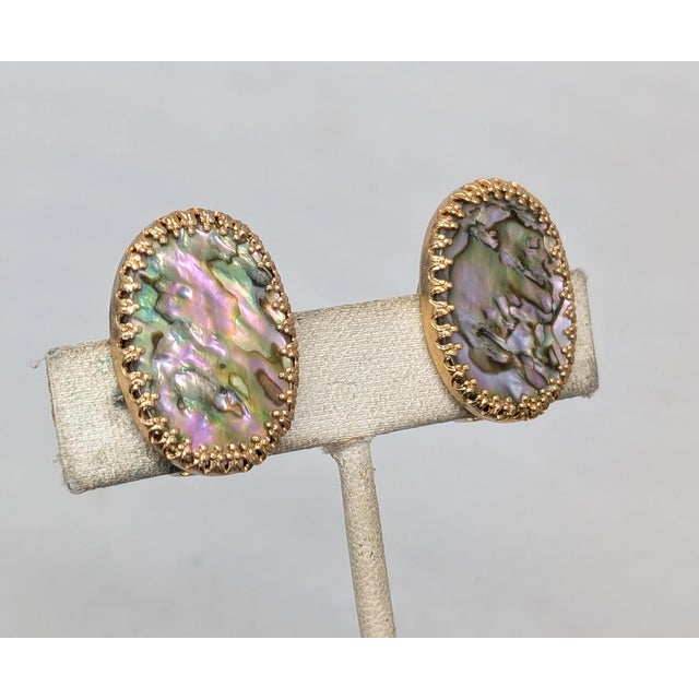 1960s goldtone oval prong set white/purple/green abalone butterfly clip back earrings. Marked "NAPIER PAT. PEND." Measure:...