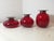 Set of three ruby ​​red Murano glass vases with a hallmarked 925 Sterling Silver rim. The color is beautiful and deep, as...