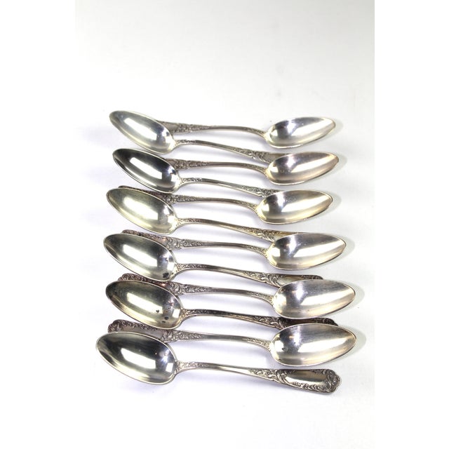 Set of 12 solid silver soup spoons with baroque vine decoration, 2 hallmarks, 1072 grams