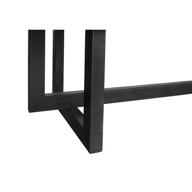 Modern dining table with oak top and steel base.