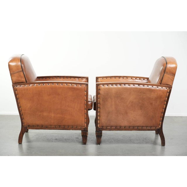 Unique set of two beautiful sheepskin Art Deco armchairs with fine wood carving and black piping. : These special Art Deco...