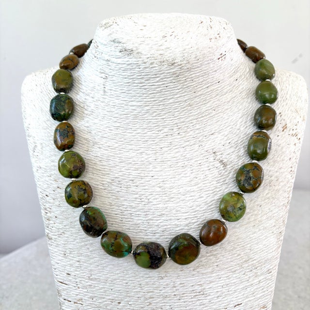 The Izo green natural turquoise chunky graduated necklace features polished, earthy green and brown matrix gemstone...