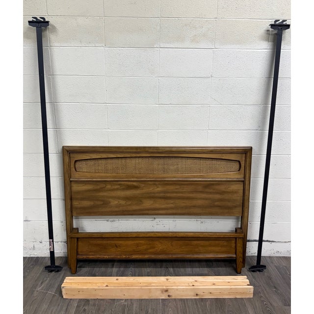 This is a beautiful vintage Mid-Century Modern full-size bed crafted in walnut with a woven cane headboard insert....