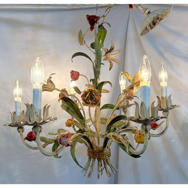 Timeless Italian tole chandelier from the mid 20th century. This unique piece has six lights with a flower motif including...
