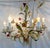 Timeless Italian tole chandelier from the mid 20th century. This unique piece has six lights with a flower motif including...