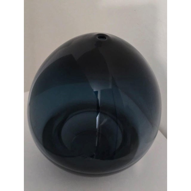 This piece demonstrates the refined use of the sommerso technique developed in Murano, with layered blue glass encased in...