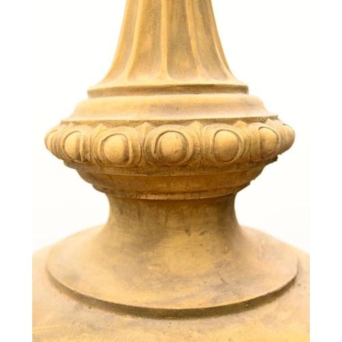 A striking pair of classical English garden finial urns mounted on square plinth bases The urns feature richly cast ram’s...