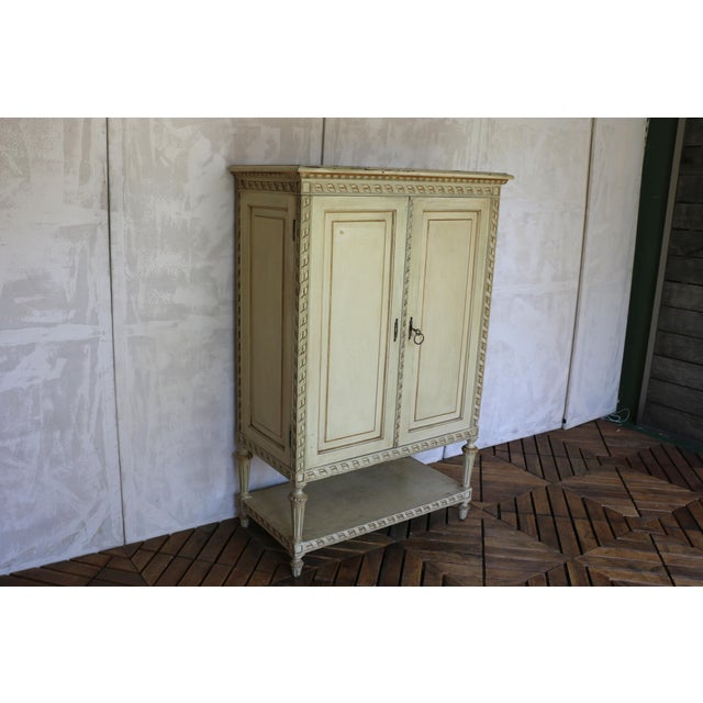 Elegant and richly detailed, this 1930s Italian cabinet showcases the timeless craftsmanship and refined ornamentation...