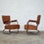 Pair of 1960s armchairs designed by józsef peresztegi, featuring a single bent tubular steel frame forming the structure,...